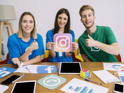 woman-holding-instagram-like-icon-with-his-friends-showing-thumbup-sign